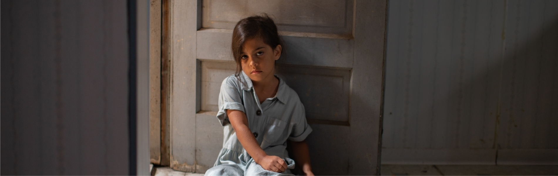 Young girl sitting on floor