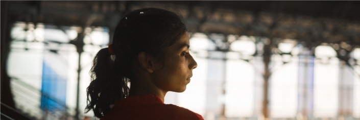 A head and shoulders photo of a woman looking off to the side