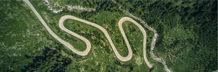 Arial view of a winding road through green countryside