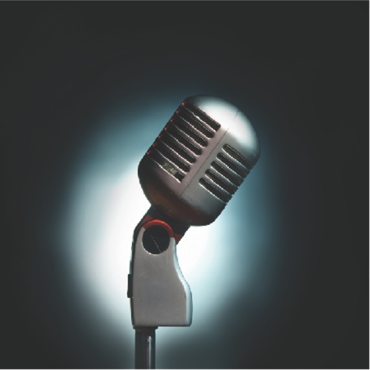 Dark black background with an old gleaming microphone in the foreground