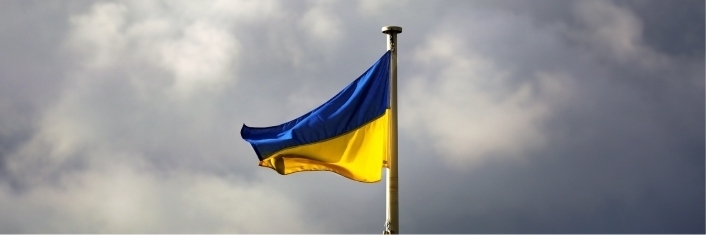 Ukrainian flag flying in grey sky
